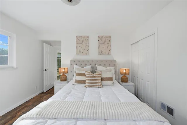 a spacious bedroom with a large bed and a window