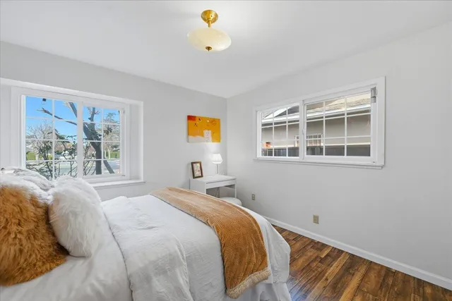 a bedroom with a bed and a potted plant