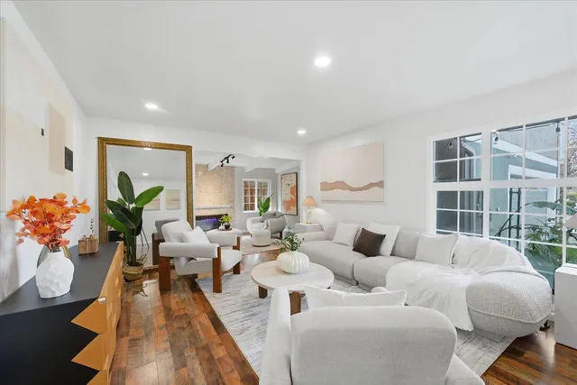 a living room with furniture potted plant and a fireplace