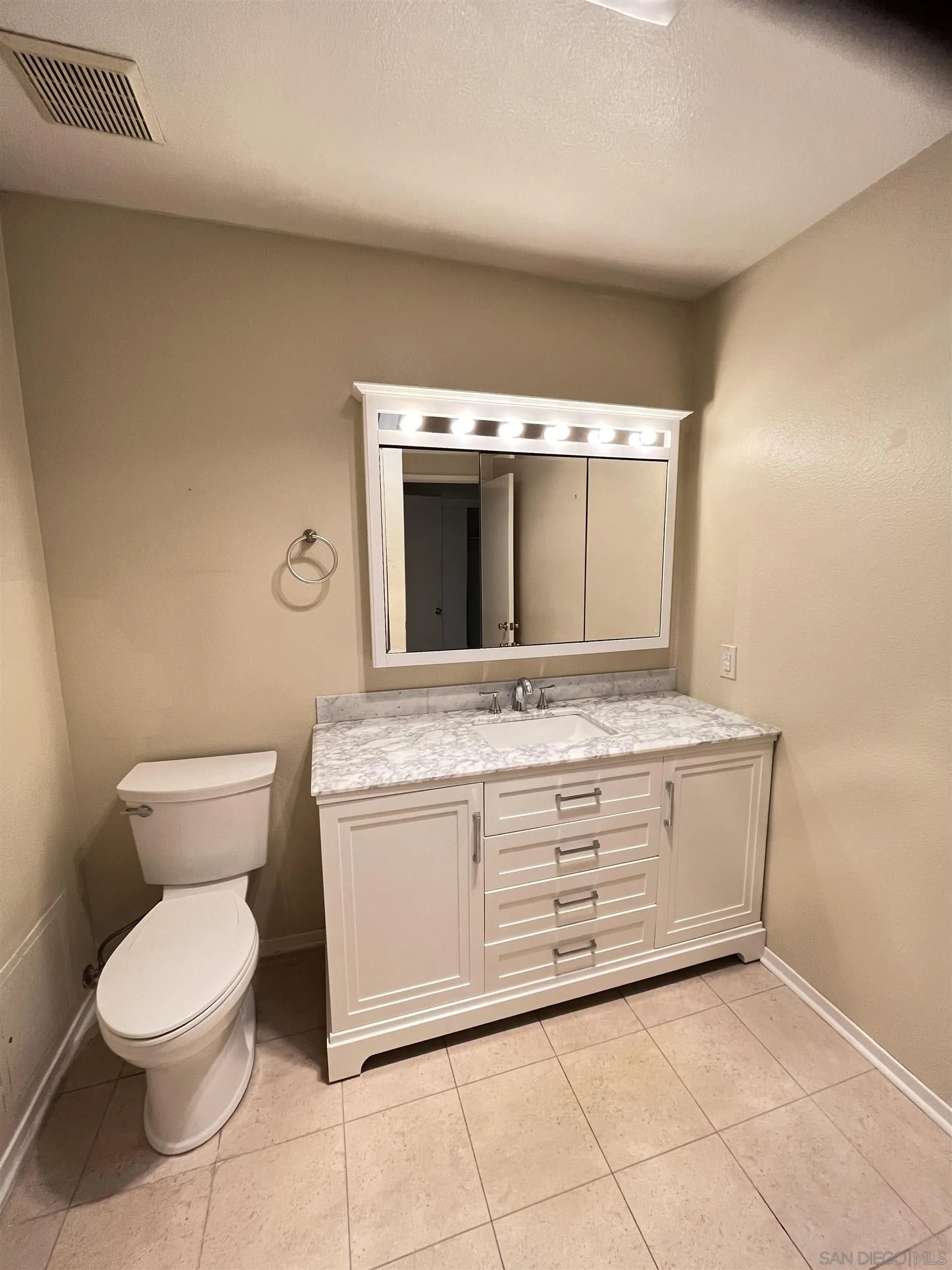 3719 Bay Leaf Way Oceanside, CA 92057 - Photo 14 of 33 a bathroom with a toilet sink and mirror
