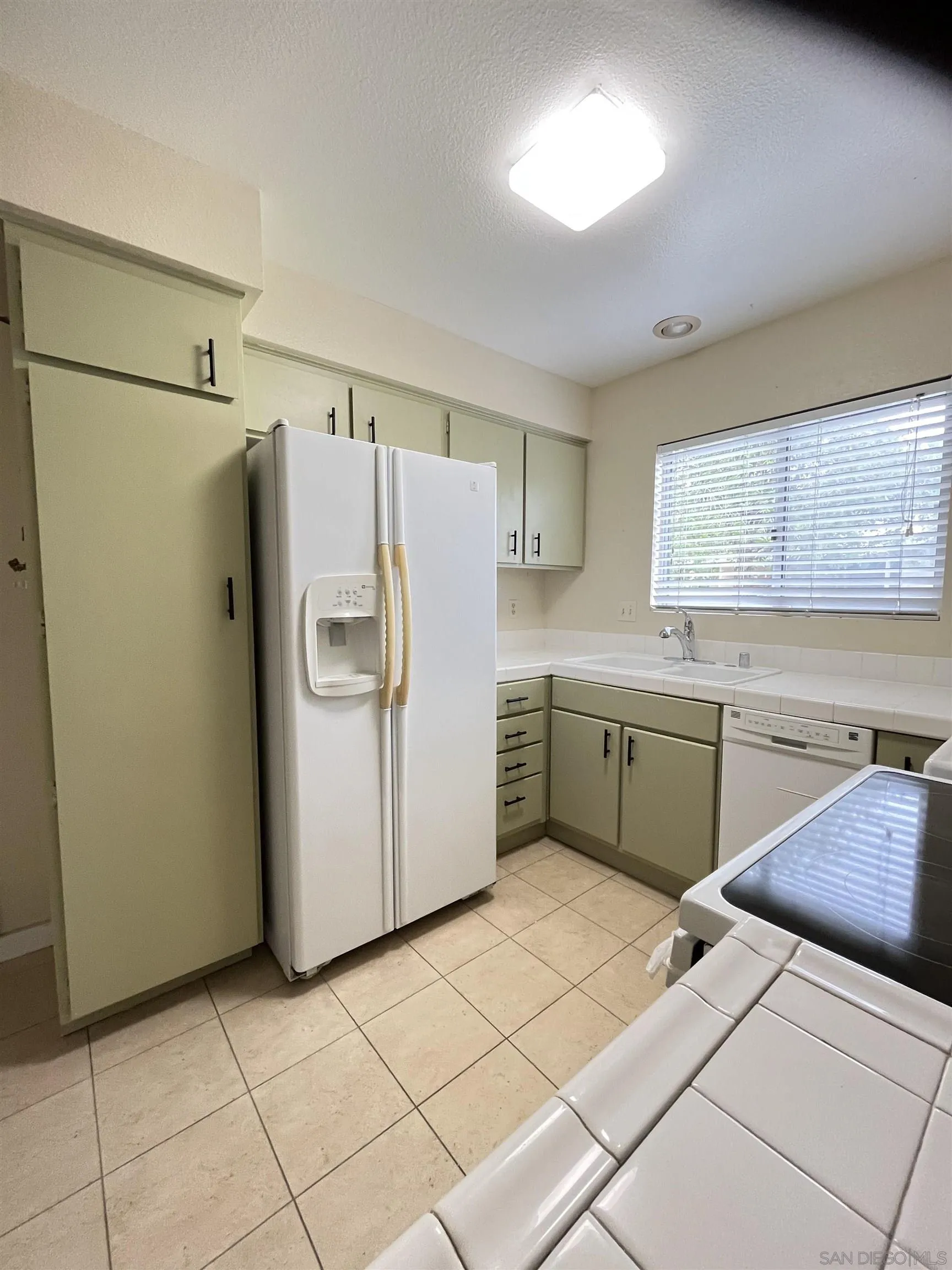 3719 Bay Leaf Way Oceanside, CA 92057 - Photo 16 of 33 a kitchen with a refrigerator sink and cabinets