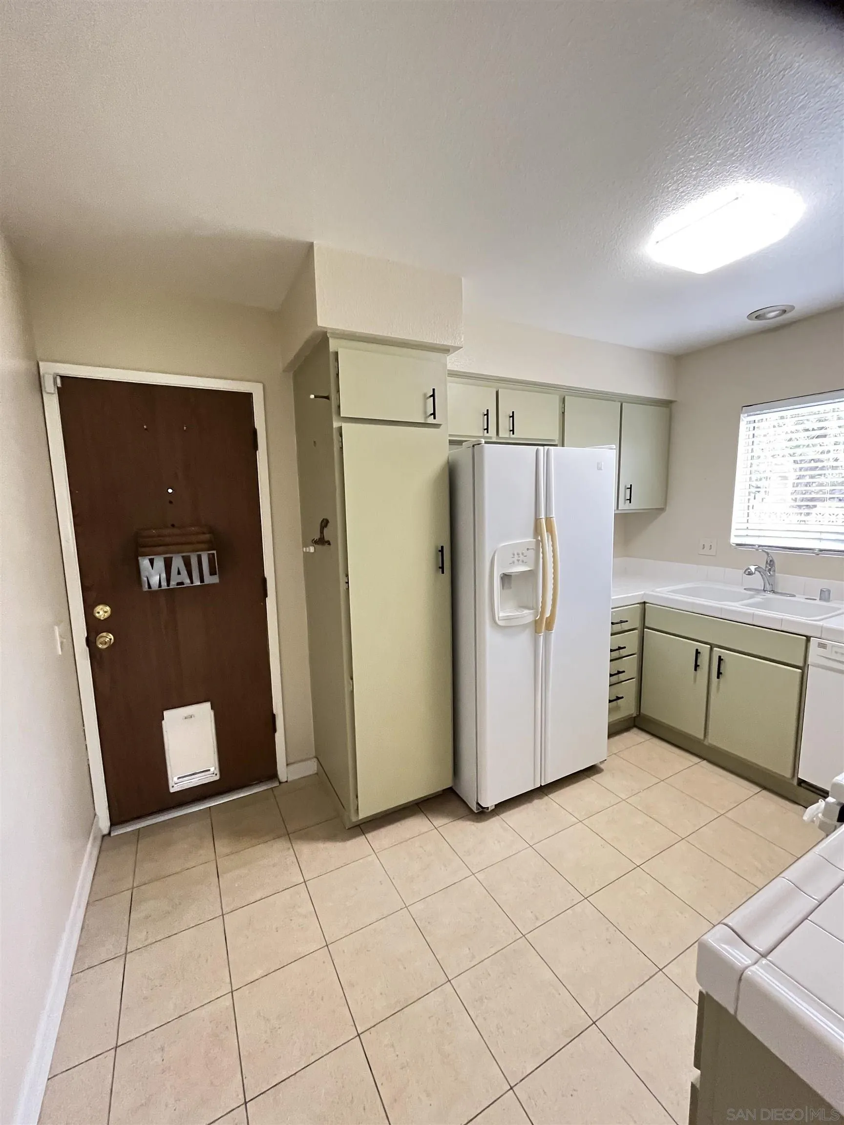 3719 Bay Leaf Way Oceanside, CA 92057 - Photo 18 of 33 a kitchen with a refrigerator and cabinets