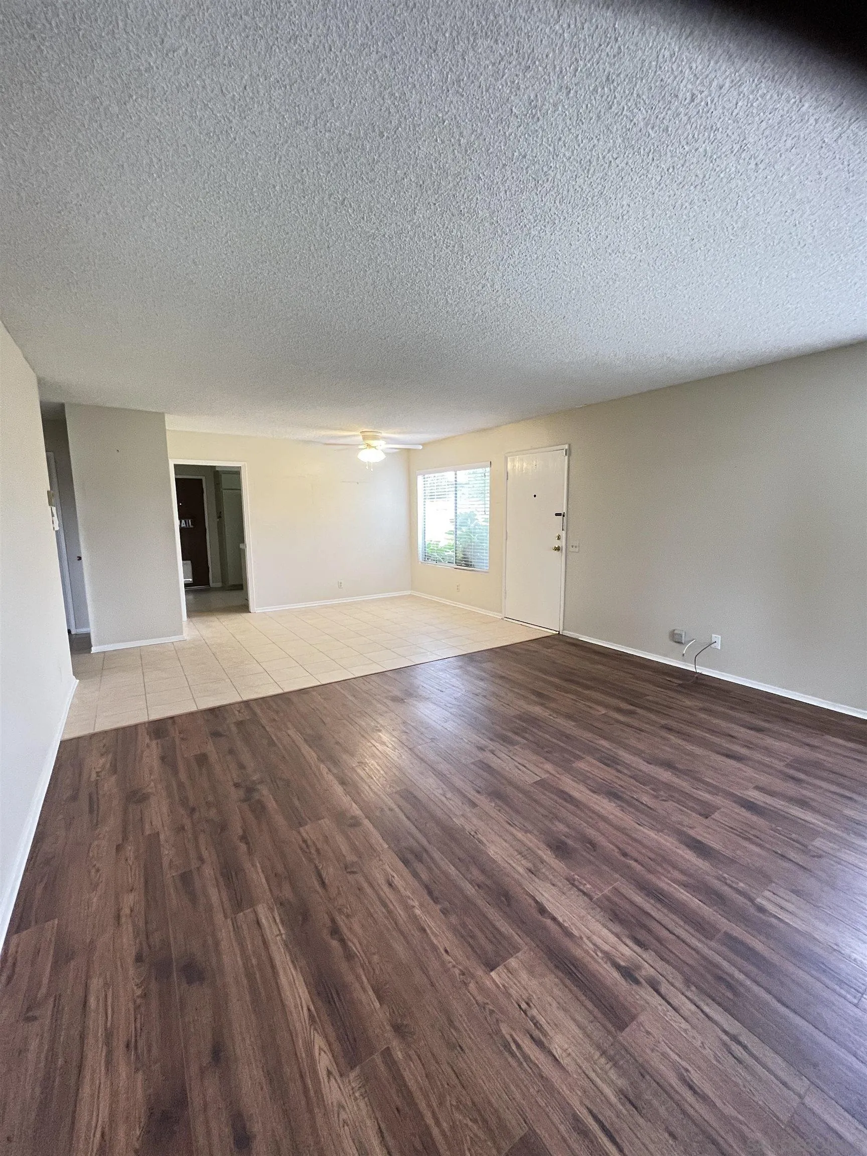3719 Bay Leaf Way Oceanside, CA 92057 - Photo 5 of 33 a view of an empty room with wooden floor and a window