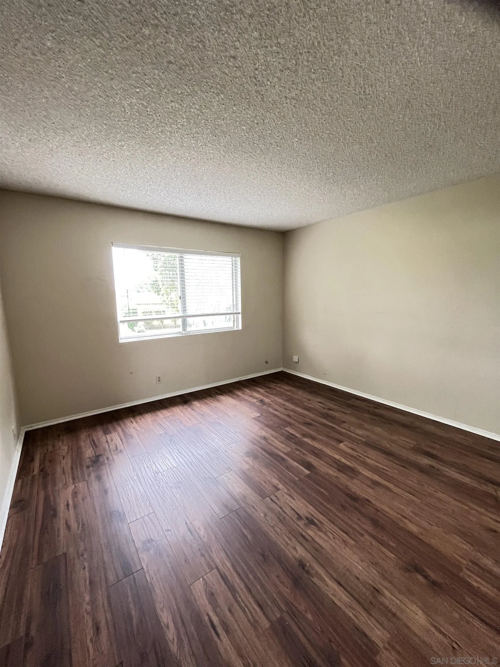 3719 Bay Leaf Way Oceanside, CA 92057 - Photo 7 of 33 an empty room with wooden floor and windows