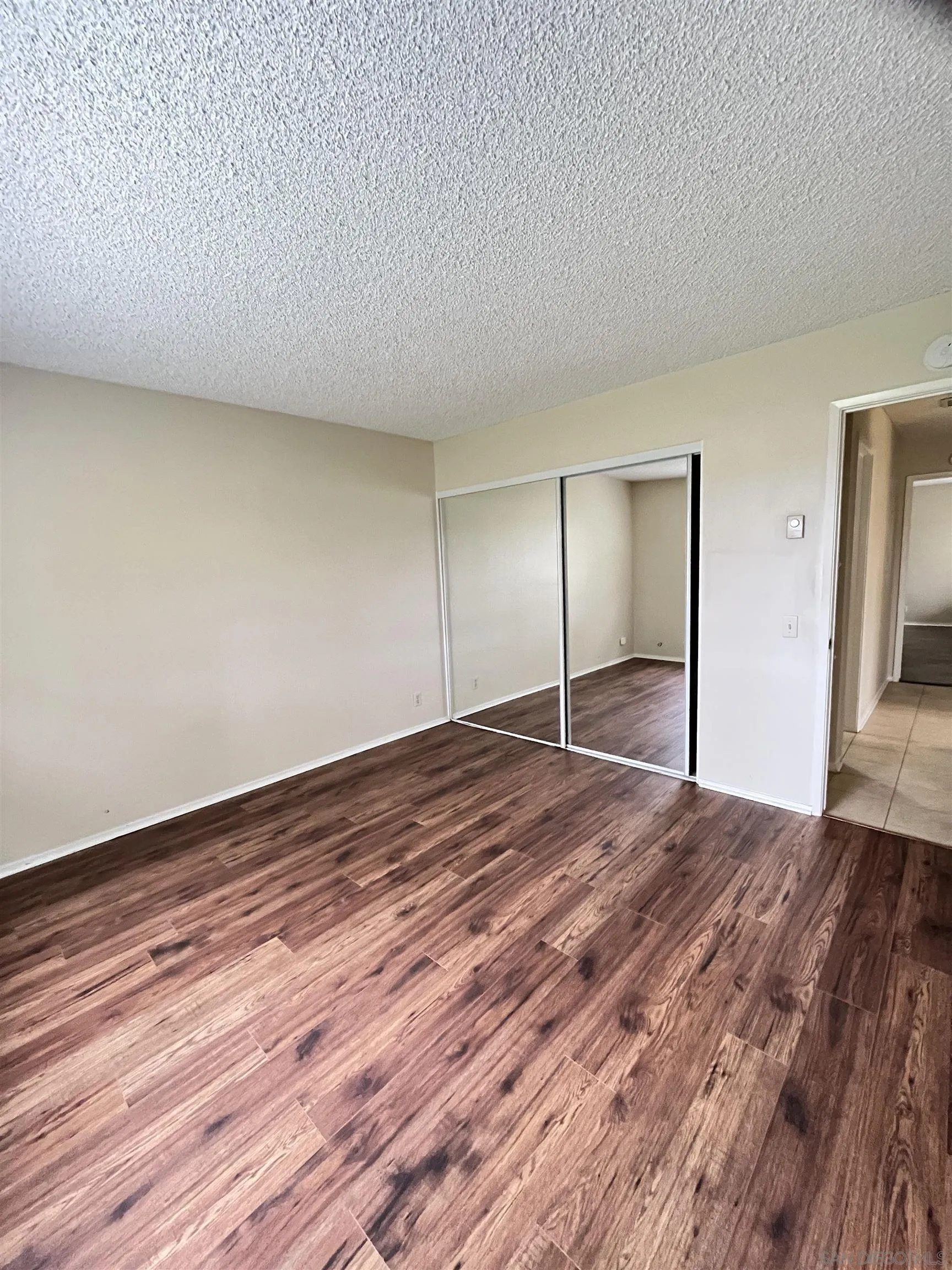 3719 Bay Leaf Way Oceanside, CA 92057 - Photo 8 of 33 a view of empty room with wooden floor