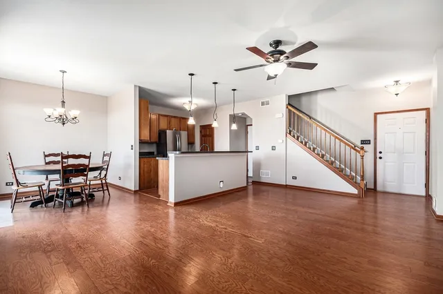 a view of a livingroom with furniture and a ceiling fan