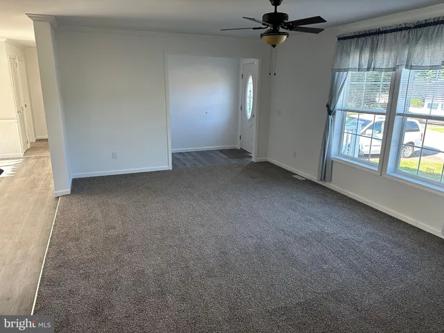 a kitchen with stainless steel appliances kitchen island granite countertop a refrigerator and a stove