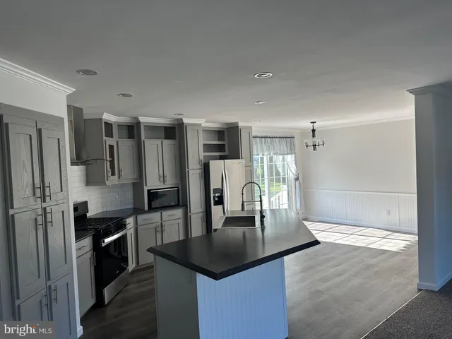 a kitchen with a refrigerator and a stove