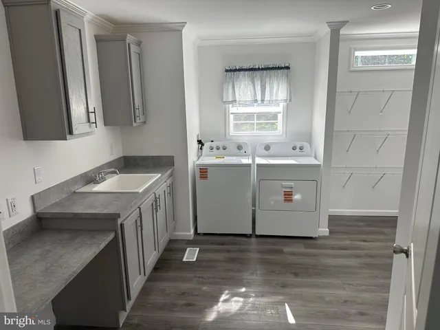 a utility room with cabinets washer and dryer