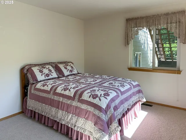 a bedroom with a bed and window