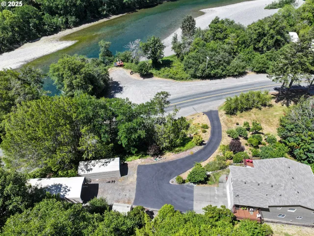 an aerial view of a house with a garden and swimming pool