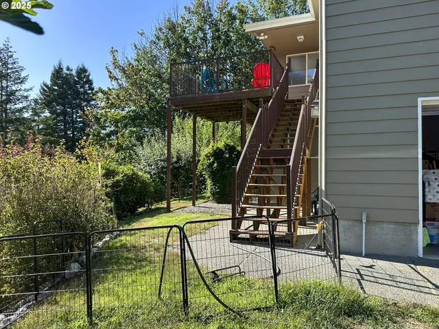 a view of a deck with wooden floor and stairs