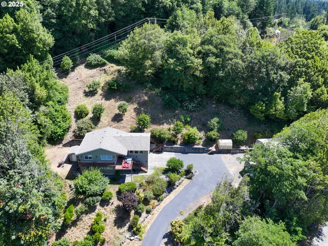 an aerial view of a house with a yard and garden