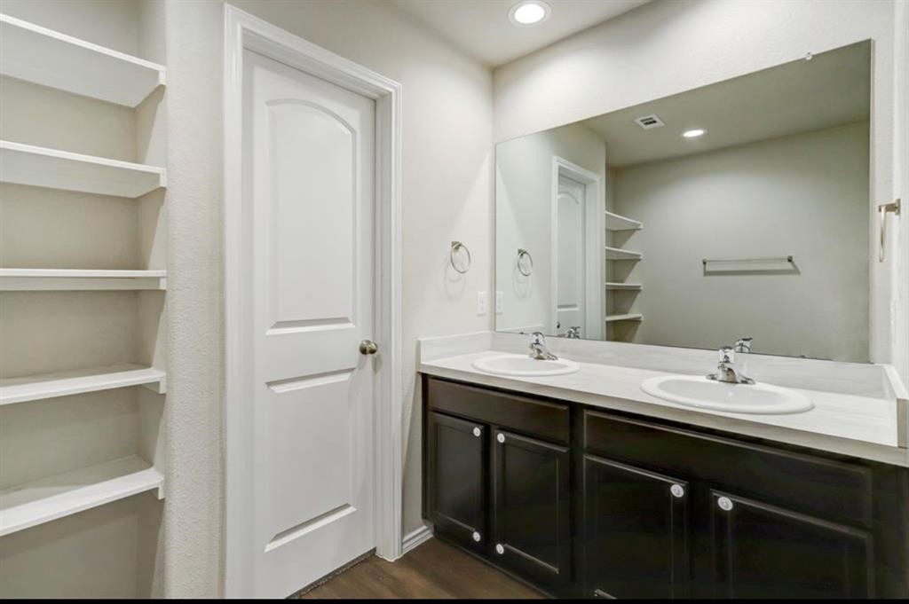 1227 Baja Vista Way Channelview, TX 77530 - Photo 12 of 25 a bathroom with a double vanity sink and mirror