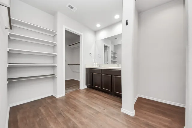 a view of a kitchen with a sink cabinets and wooden floor