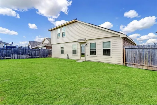 a view of a house with a yard and sitting area