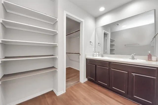 a bathroom with a sink double vanity and a mirror