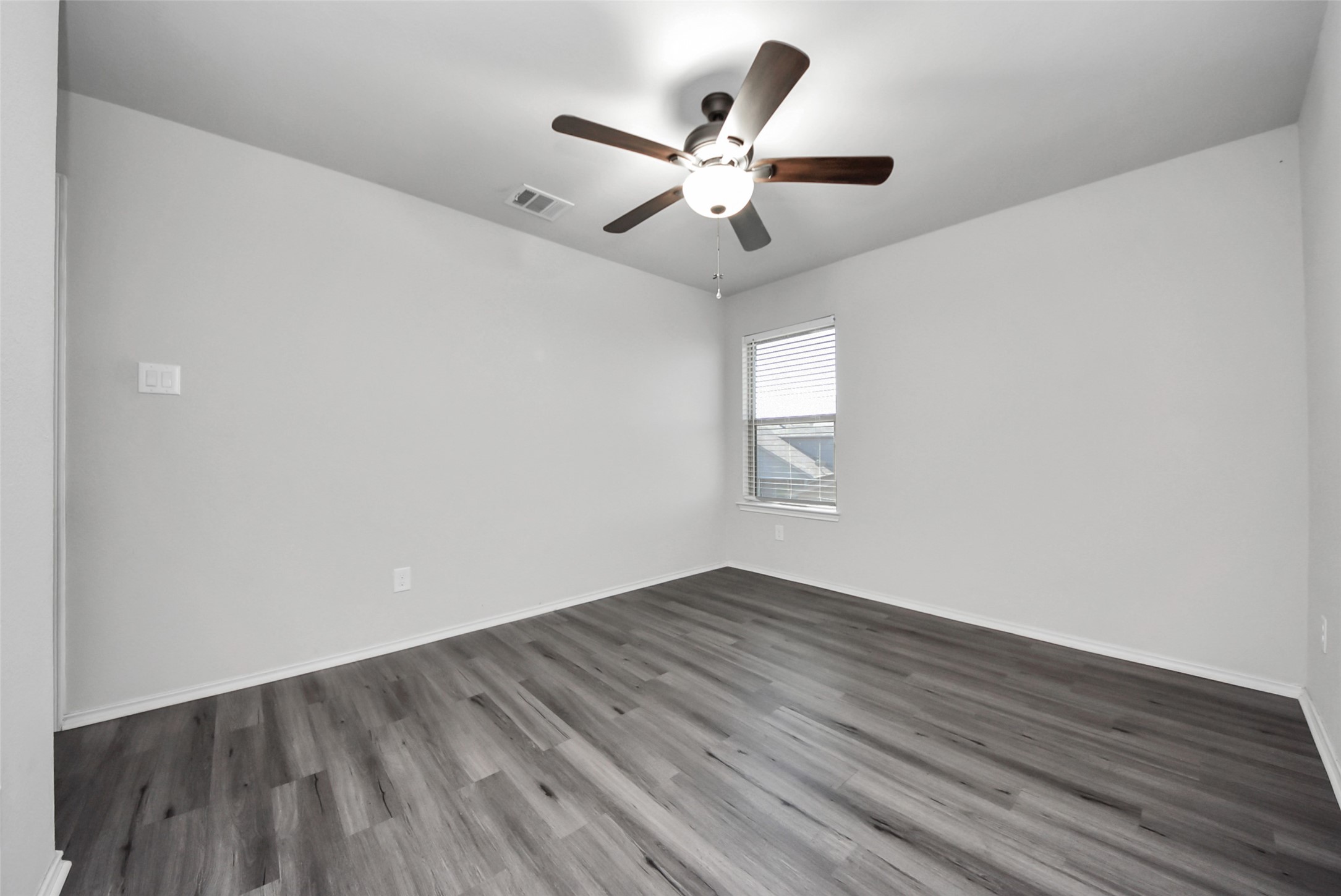 1227 Baja Vista Way Channelview, TX 77530 - Photo 18 of 25 an empty room with wooden floor fan and windows