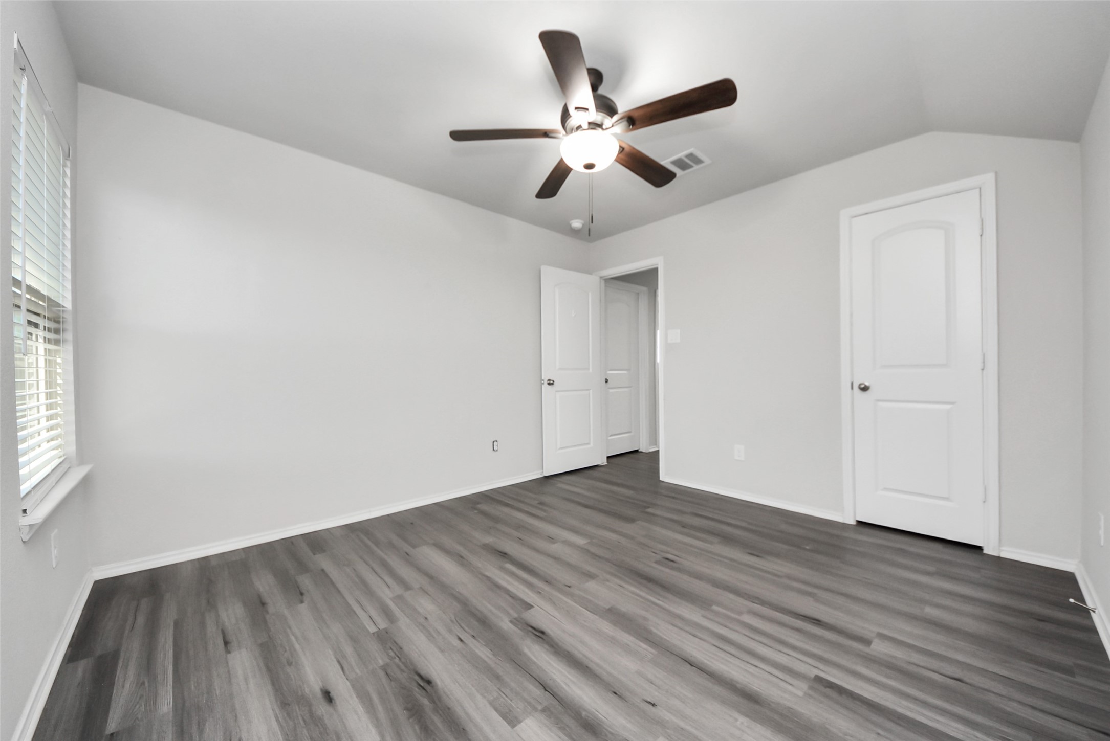 1227 Baja Vista Way Channelview, TX 77530 - Photo 19 of 25 an empty room with wooden floor fan and windows