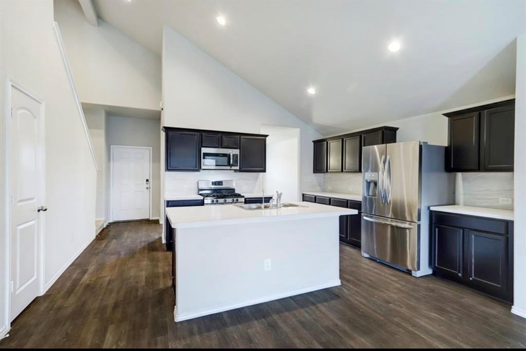1227 Baja Vista Way Channelview, TX 77530 - Photo 6 of 25 a kitchen with refrigerator a microwave and cabinets