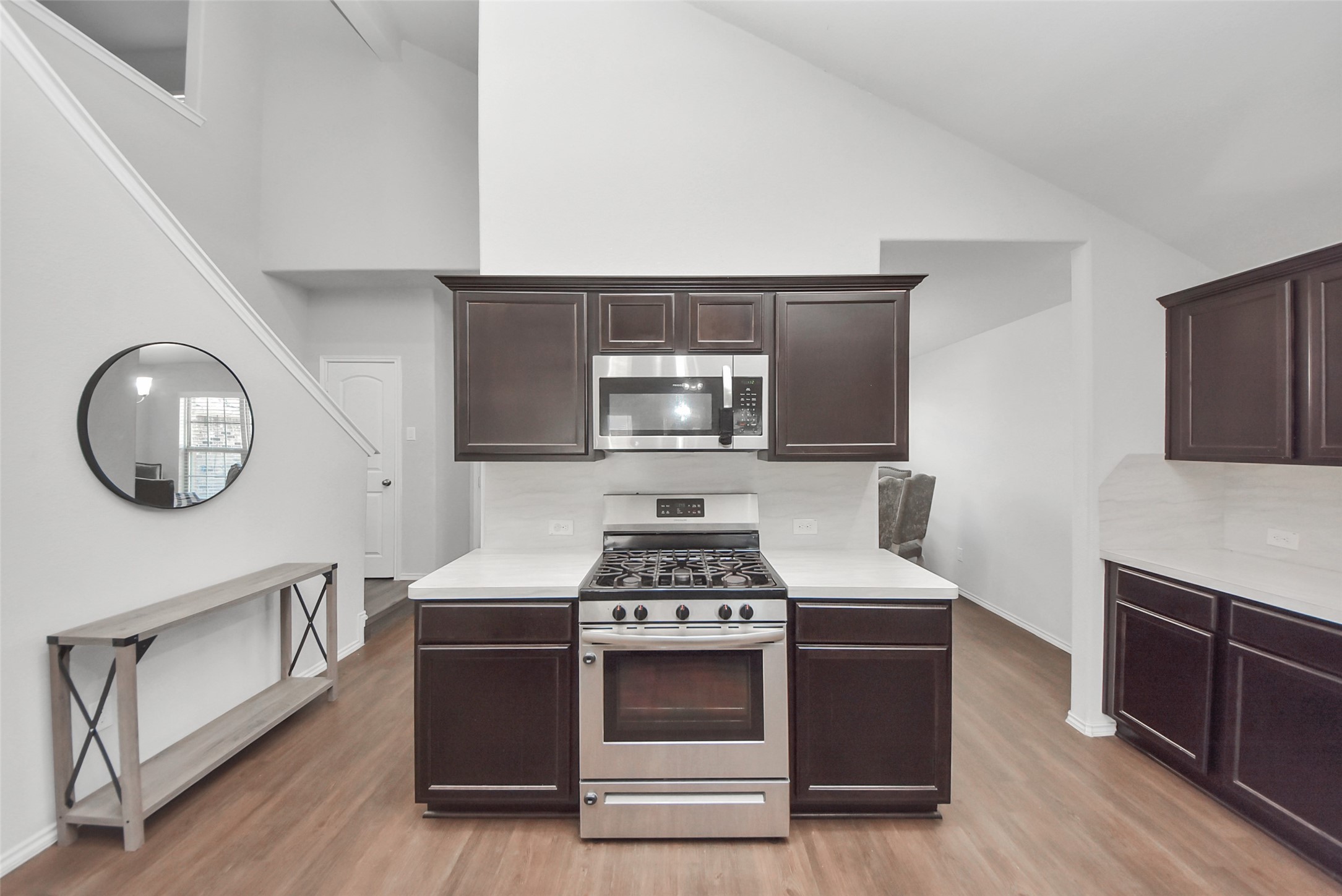 1227 Baja Vista Way Channelview, TX 77530 - Photo 9 of 25 a kitchen with stainless steel appliances a stove a microwave and cabinets