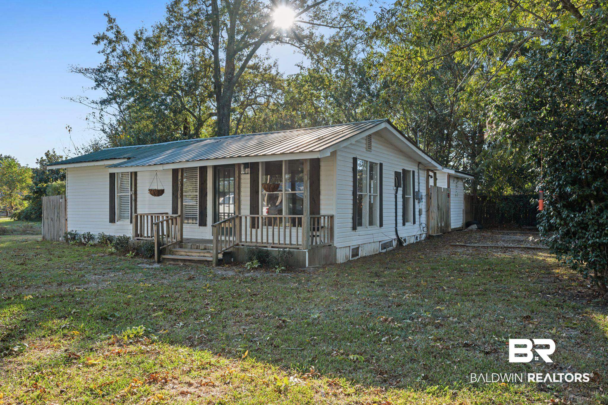 503 North Holly Street Foley, AL 36535 - Photo 2 of 23 View of front facade with a front yard and covered porch