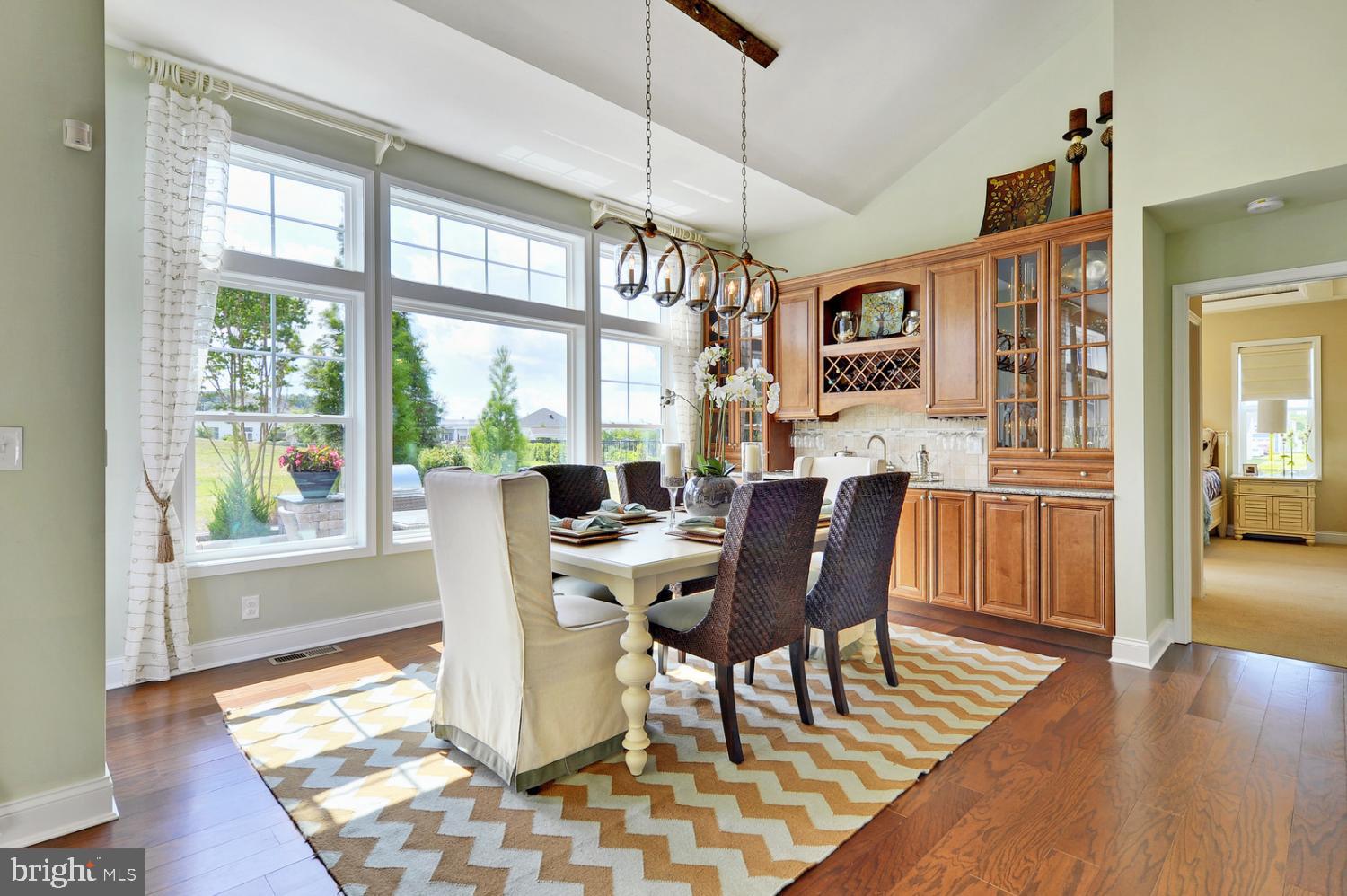 25027 Leland Avenue Harbeson, DE 19951 - Photo 15 of 21 a dining room with furniture a chandelier and wooden floor