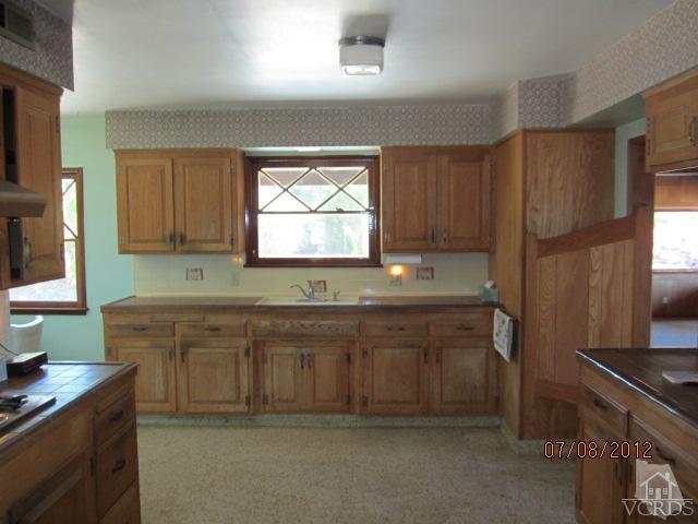 15 Vientos Road Camarillo, CA 93010 - Photo 11 of 25 a kitchen with stainless steel appliances granite countertop a sink a stove a refrigerator and island