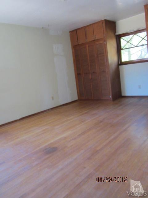15 Vientos Road Camarillo, CA 93010 - Photo 18 of 25 an empty room with wooden floor and windows
