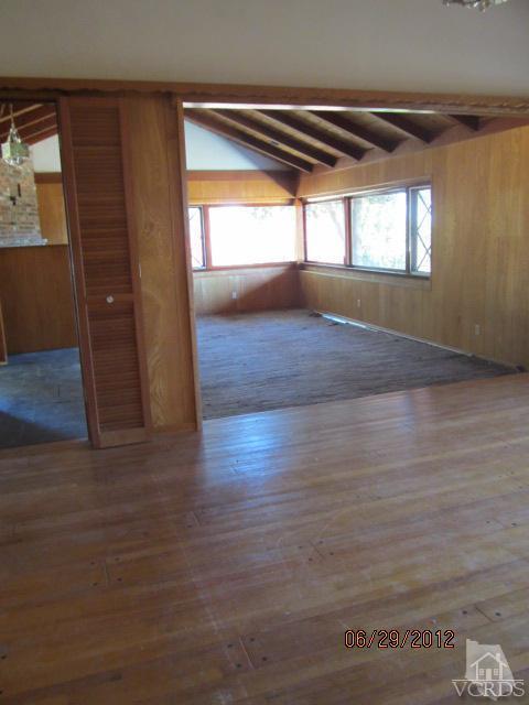 15 Vientos Road Camarillo, CA 93010 - Photo 9 of 25 an empty room with wooden floor and windows