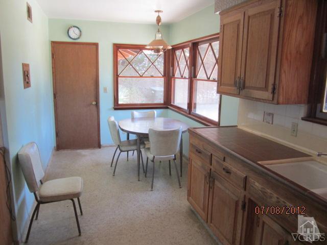 15 Vientos Road Camarillo, CA 93010 - Photo 10 of 25 a kitchen with a table chairs sink and cabinets