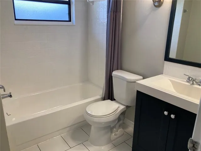 a bathroom with a sink toilet and mirror