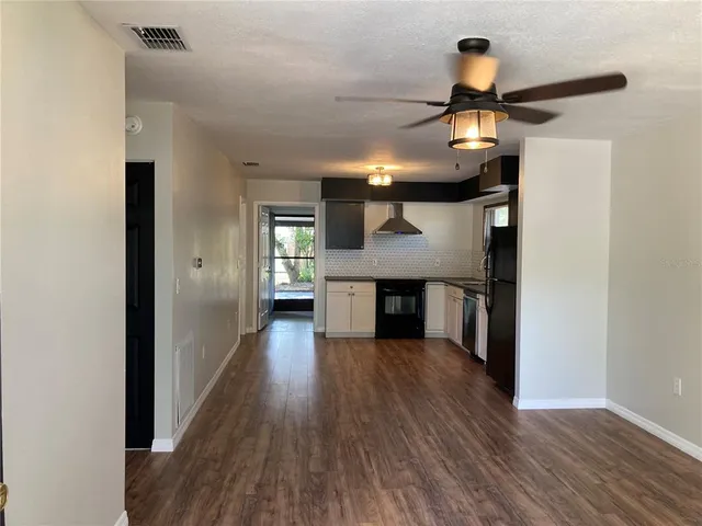 a view of a kitchen counter space and wooden floor