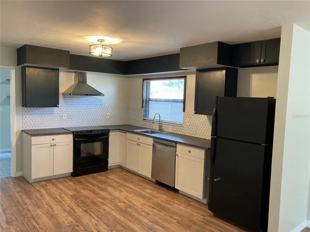 a kitchen with a refrigerator and a sink