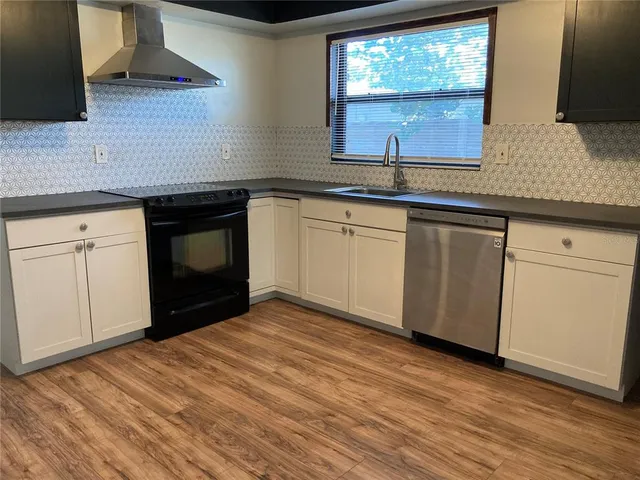 a kitchen with granite countertop a sink and a stove