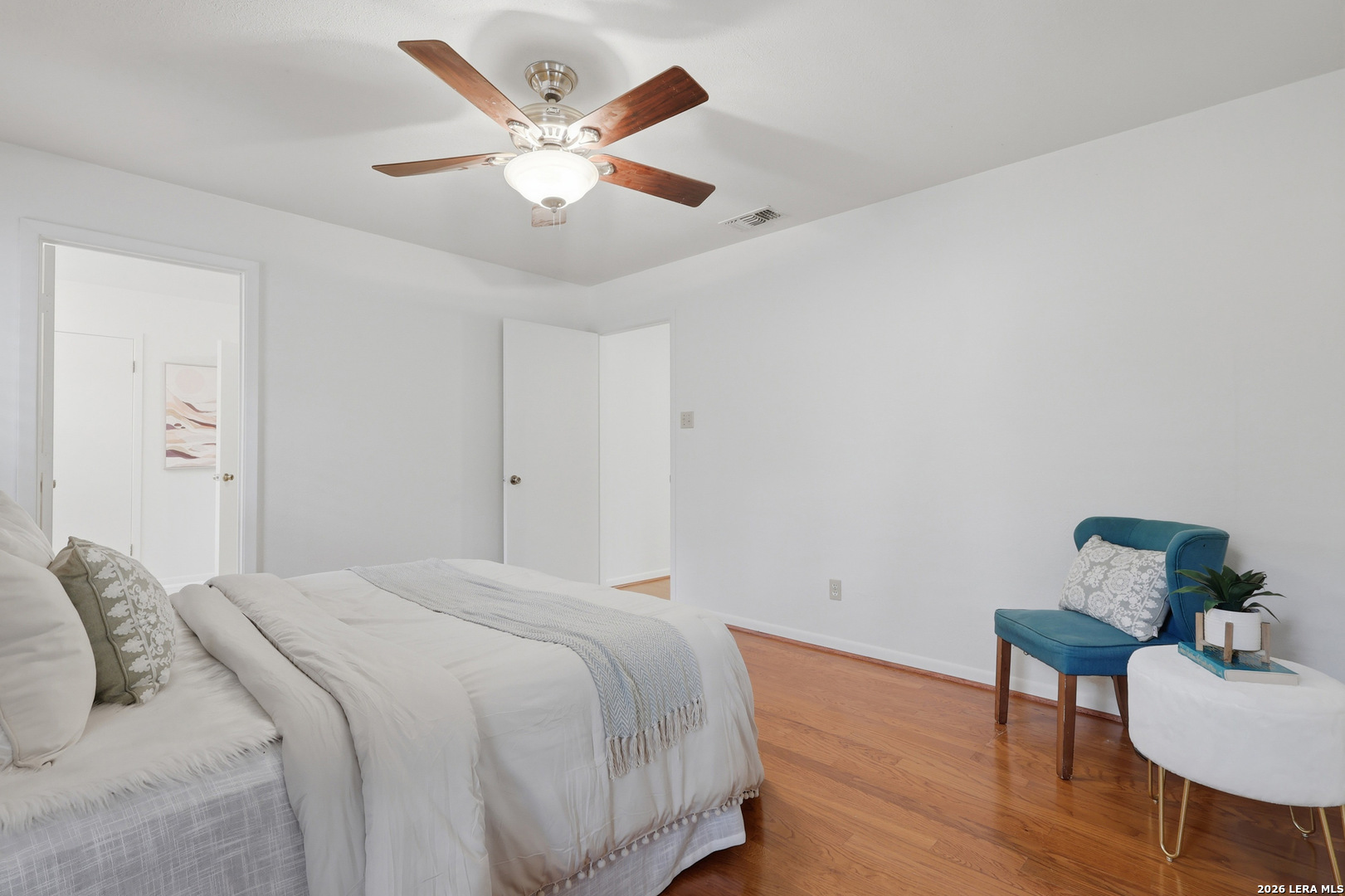 261 Fawn Lane Spring Branch, TX 78070 - Photo 16 of 44 a bedroom with a bed and a chandelier
