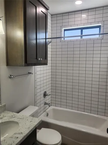 a kitchen with granite countertop cabinets and window