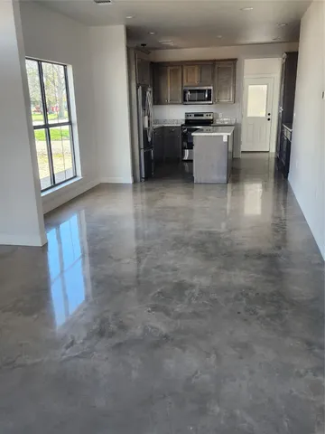 an empty room with windows and closet