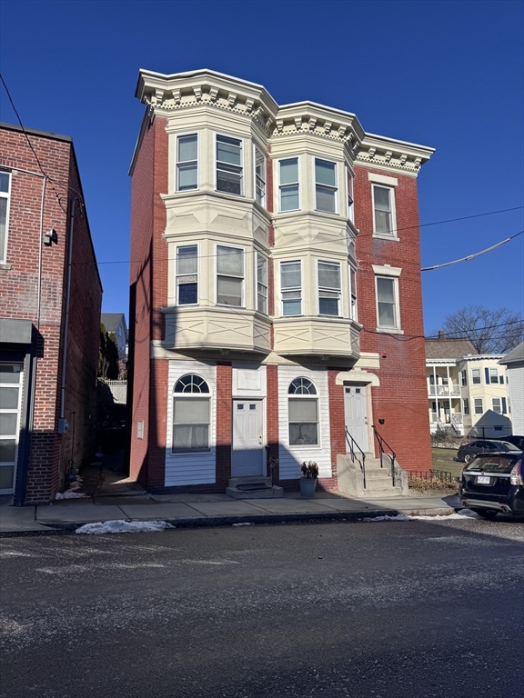 a front view of a residential apartment building with a yard