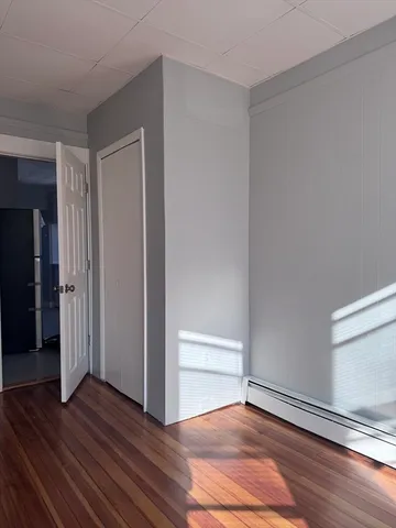 a view of an empty room and wooden floor