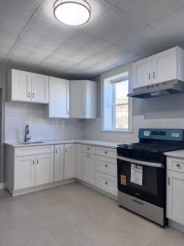 a kitchen with cabinets appliances and a sink
