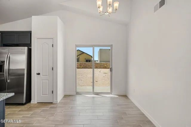 an empty room with wooden floor and mirror