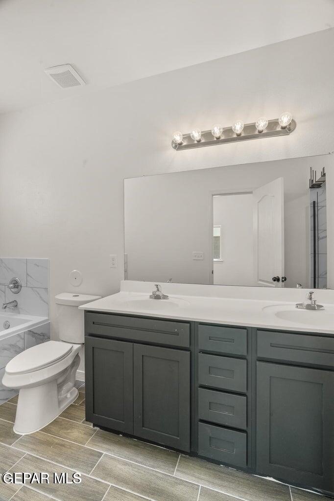 13090 Beccles Street El Paso, TX 79928 - Photo 10 of 23 a bathroom with a sink and a toilet