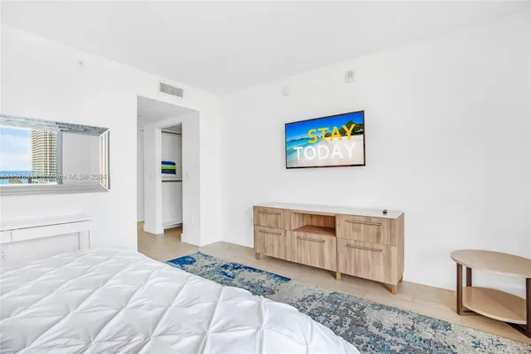 a bedroom with a bed and a cabinets