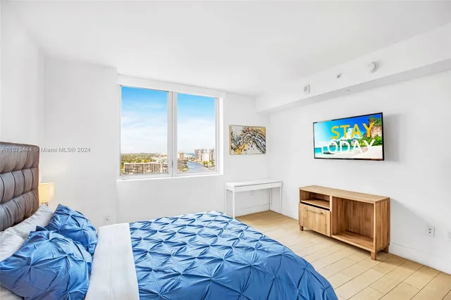 a bedroom with a large bed and a window