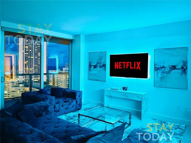 a large living room with furniture and a large window