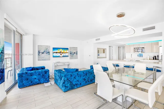 a dining room with furniture and wooden floor