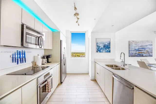 a kitchen with a sink stove and cabinets