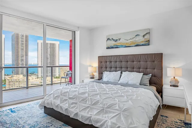 a bedroom with a large bed and a large window