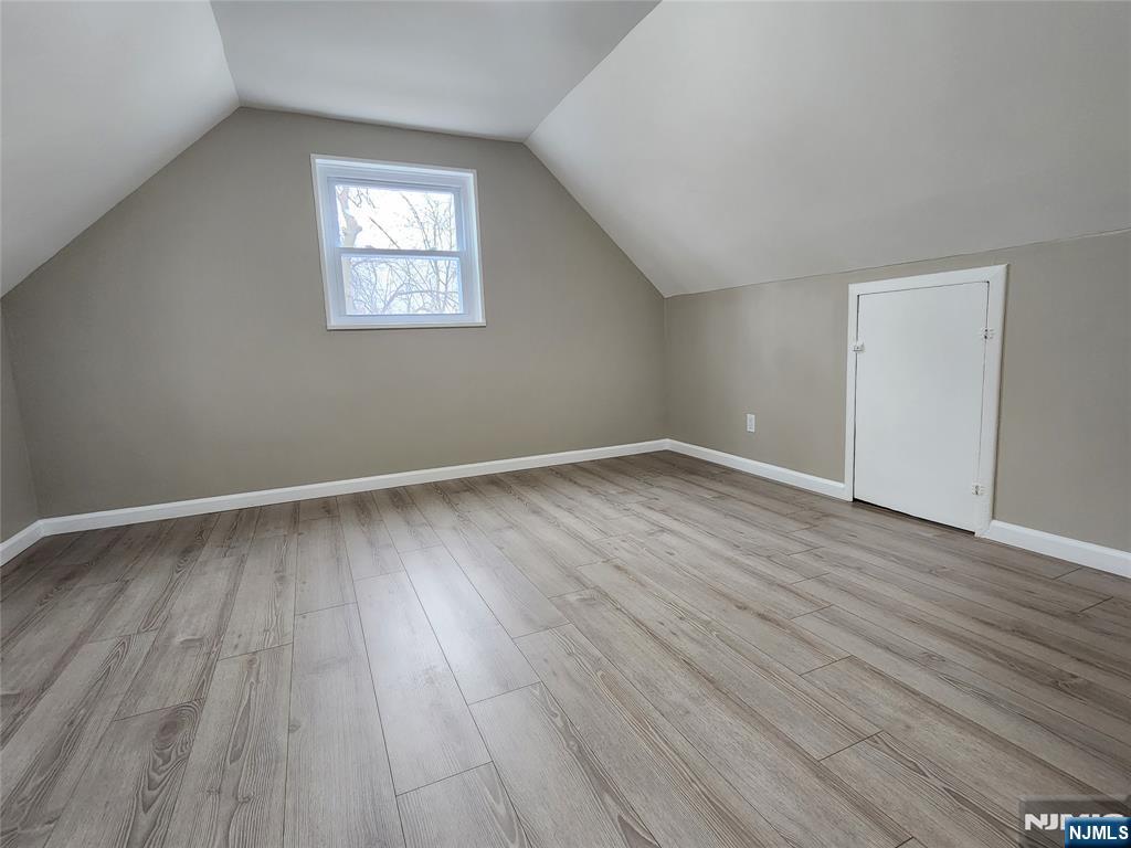 111 Church Street Lodi, NJ 07644 - Photo 13 of 21 a view of an empty room with wooden floor and a window
